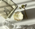Matcha Mocha · Precision lifestyle — fluted glass matcha latte with gold spoon, soft natural light.