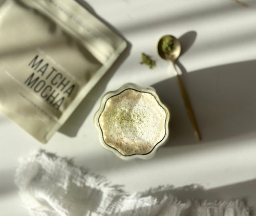 Matcha Mocha · Precision lifestyle — fluted glass matcha latte with gold spoon, soft natural light.