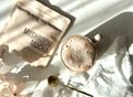 Mushroom Mocha · Foundation lifestyle — warm cacao mocha in a stoneware mug beside the pouch, soft morning light, florals.